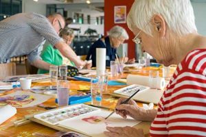 Woman doing arts and crafts at memory care.