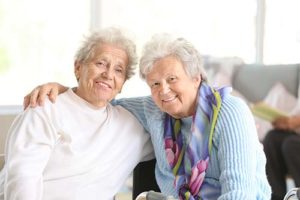 to senior women hugging while discussing fort worth texas senior living activities