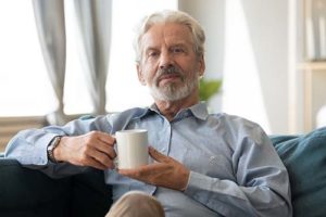 Man enjoys cup of coffee in senior independent living.