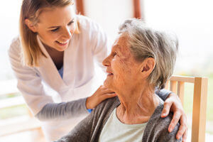 nurse helping a resident get settled in skilled nursing senior living homes