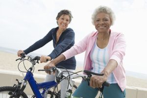 two senior women bicycling during melbourne florida senior living activities