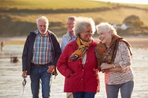 seniors walking along the beach during boynton beach florida senior living activities