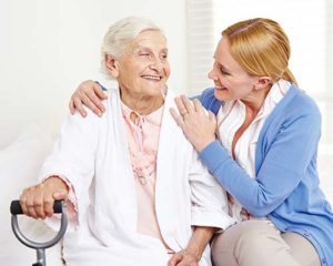 Woman receiving help at senior assisted living at Discovery Village.