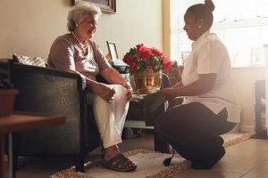 Senior woman receives help at senior independent living at Discovery Village.