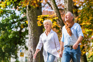 two seniors walking in a park during jacksonville florida senior living activities