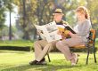 Mature couple relaxing on a bench in park